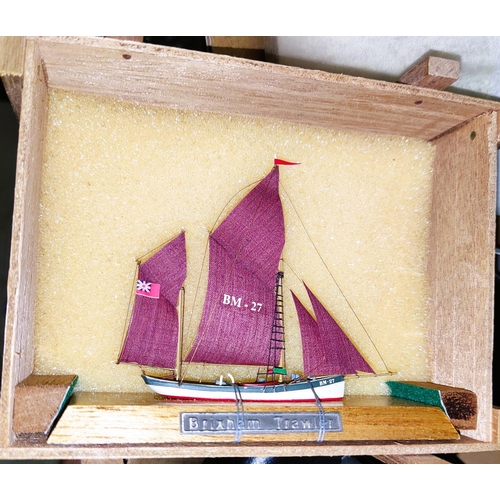 132 - A miniature of 'Brixham Trawler and three vintage cameras.