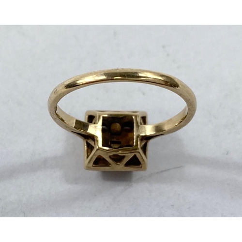 612 - A 9 carat gold dress ring with square red stone setting, 2.8gms.