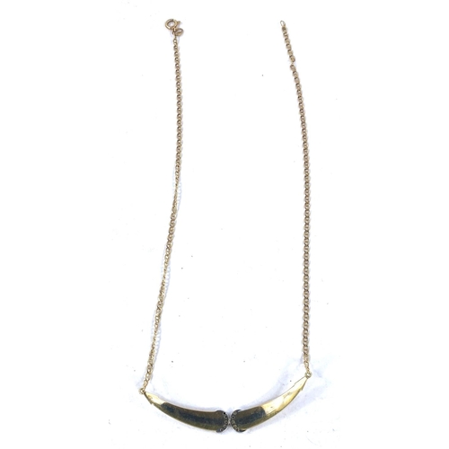 689 - A 2 tone metal necklace, stamped '750', the central ribbed pendant set diamond studded back to back ... 