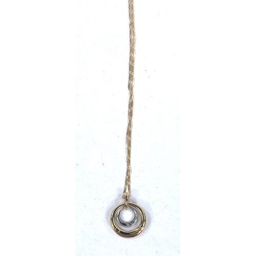 694 - A 2 tone circular metal pendant, stamped '375', 2.3gm; a fine yellow metal chain, stamped '750', 3.1... 