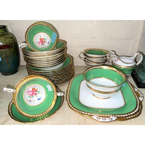 578B - A late 19th/early 20th century part tea set with green and gilt borders and polychrome floral bouque... 