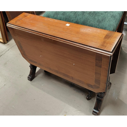 980 - An Edwardian inlaid mahogany Sutherland table on turned legs