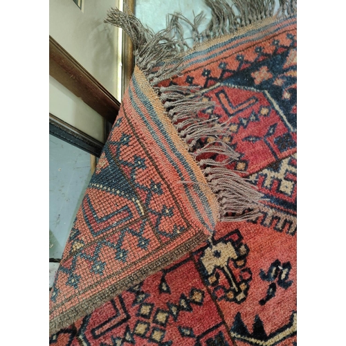 982 - A rust ground hand knotted Persian rug