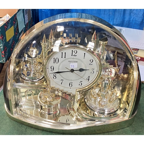 33 - A cuckoo clock; a modern gilt mantel clock; a 1930's barometer