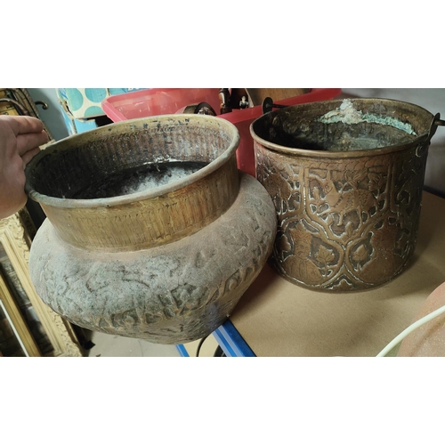 51 - A Middle Eastern large embossed brass jardinière; a similar copper bucket
