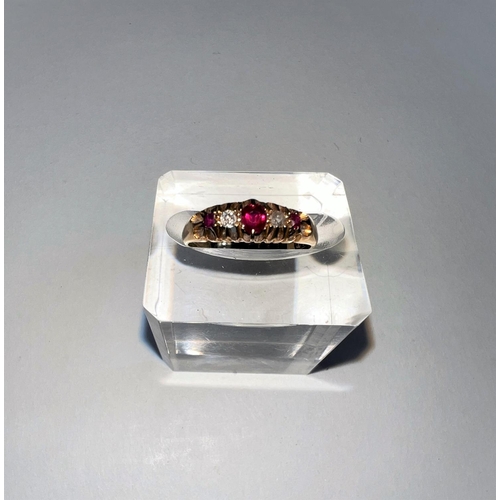 642 - An 18 carat hallmarked gold gypsy style dress ring set 3 rubies and 2 old cut diamonds in split shan... 