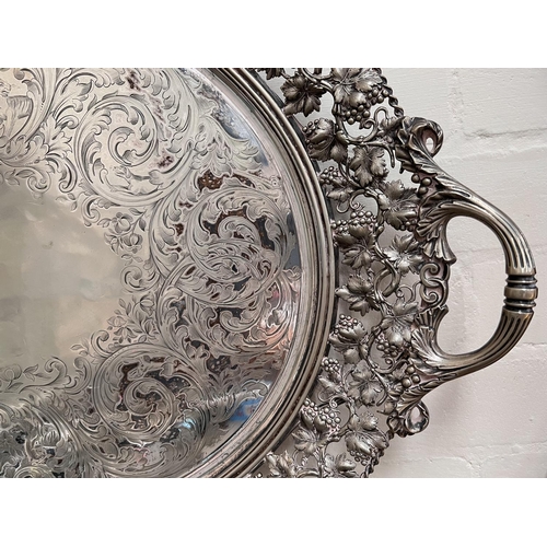 681 - A 19th century silver plated large oval tray with pierced vine border and chased decoration, length ... 