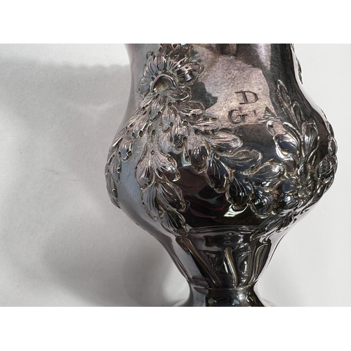 714 - A Georgian hallmarked silver baluster cream jug on pedestal base with embossed swags, London 1773, 3... 