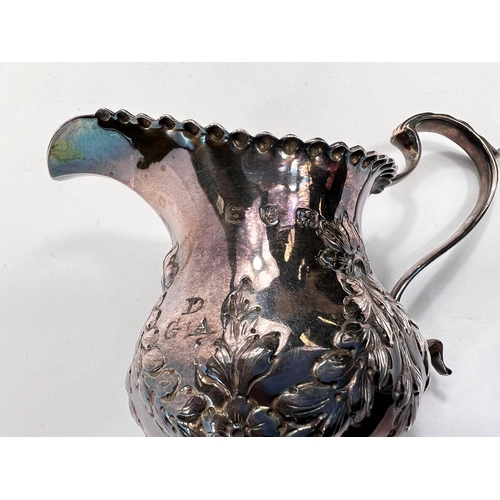 714 - A Georgian hallmarked silver baluster cream jug on pedestal base with embossed swags, London 1773, 3... 