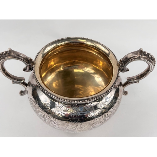 715 - A 19th century hallmarked silver 2-handled bowl of squat circular form, with chased decoration and r... 