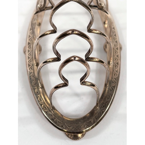 720 - A hallmarked silver gothic arch toast rack with 6 divisions on chased oval base and 4 beaded pad fee... 