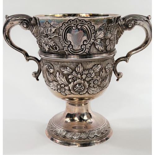 731 - A hallmarked silver pair of Irish cast loving cups with twin handles, extensive relief decoration of... 