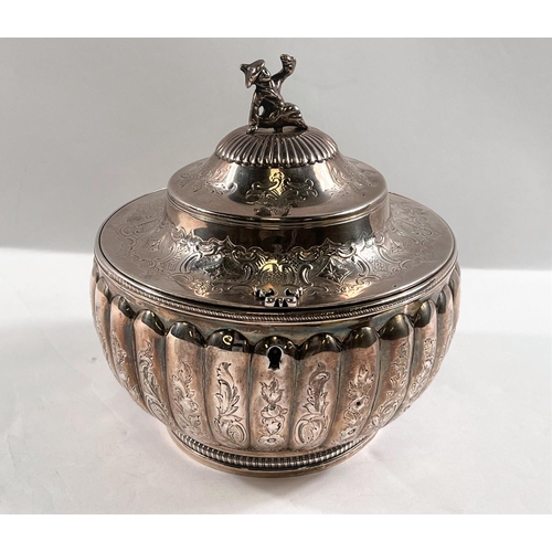 789 - A George III silver tea caddy of melon form, engraved decoration, waisted domed lid with figural fin...