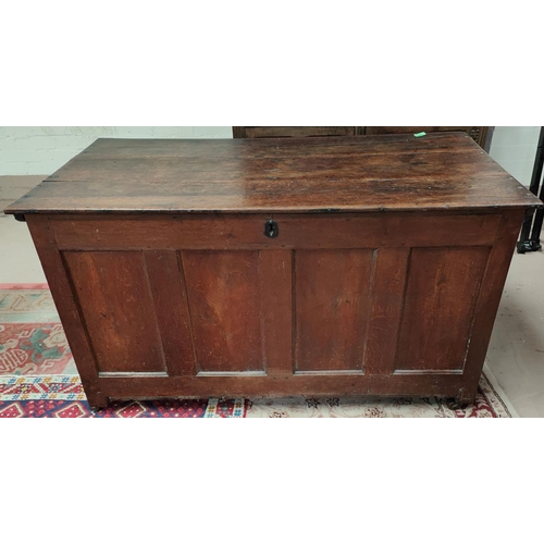 1002 - An 18th century oak panelled blanket box with hinged lid