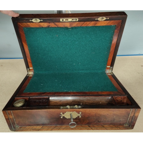 106 - A Victorian lap desk in crossbanded walnut and rosewood, with extensive brass inlay and fitted inter... 