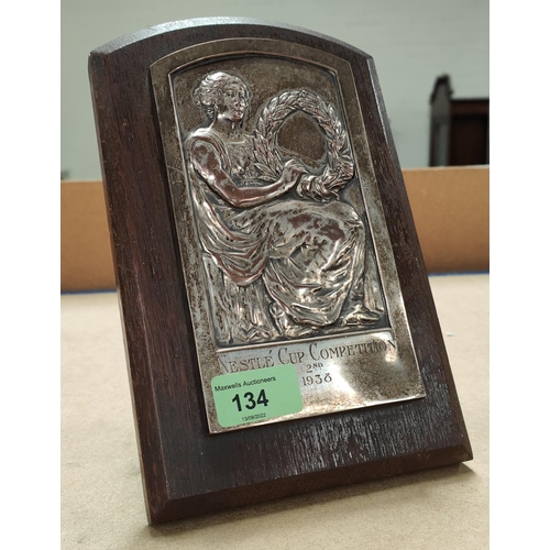 134 - A 1930's silver on copper plaque with young woman and laurel crown, lettered 