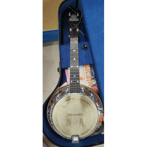 146 - A George Formby ukulele banjo in bird's eye maple and chrome, in a case with booklet and music