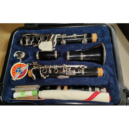 147 - A Selmer Pride clarinet in fitted box with music and folding music stand