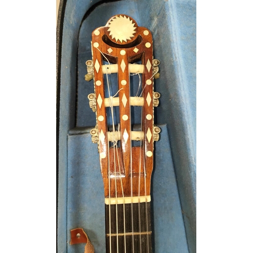 154A - An inlaid parlour guitar, the body with box wood inlay and mother of pearl extensive inlay to other ... 