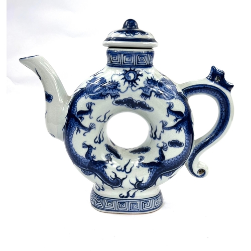 486 - A Chinese blue and white teapot with central hole and 4 character mark to base. HeightA Stone ware b... 