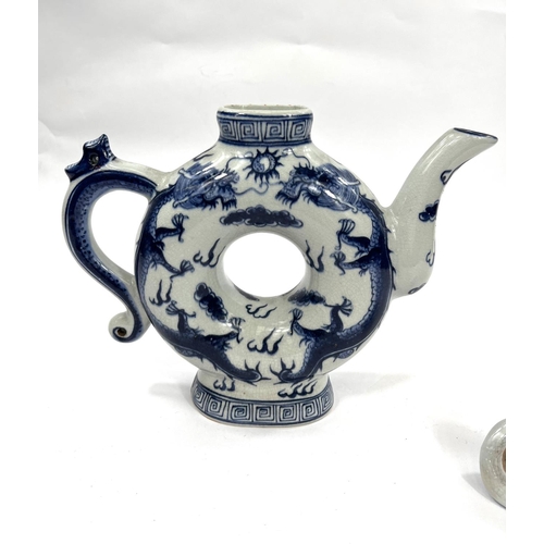 486 - A Chinese blue and white teapot with central hole and 4 character mark to base. HeightA Stone ware b... 