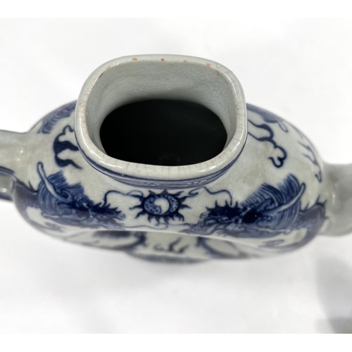 486 - A Chinese blue and white teapot with central hole and 4 character mark to base. HeightA Stone ware b... 