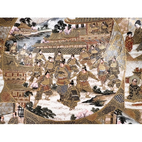 497 - A finely decorated 19th century Japanese satsuma dish decorated with panels of warriors and traditio... 