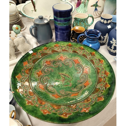 520C - A large Stoneware plaque with green lustre ground in the Portuguese manner with other Studio pottery... 