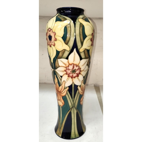 534 - A Moorcroft vase  of inverted baluster form decorated with narcissi against a dark blue ground,... 