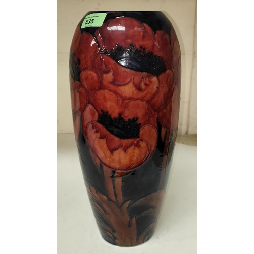 535 - A Moorcroft large baluster vase decorated with poppies under a flambé glaze and dark blue gro... 