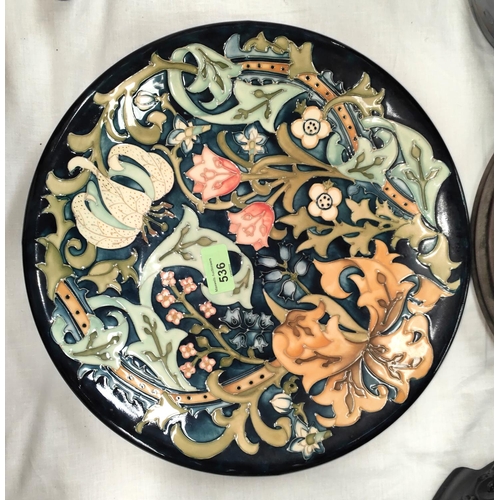 536 - A Moorcroft large circular shallow dish decorated with stylised leaves and flowers in the style of W... 