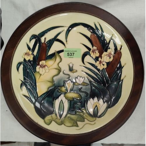 537 - A Moorcroft circular shallow dish decorated with spring flowers against a yellow ground, impressed a... 