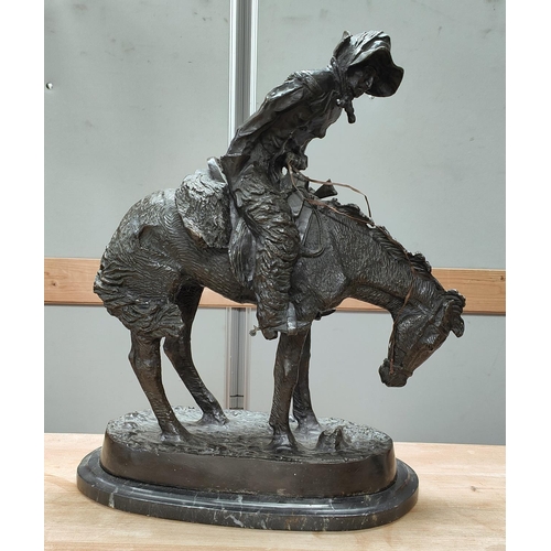 59 - Follower of Fredric Remmington, Cowboy on horse back, bronze, bears signature, marble plinth height ... 