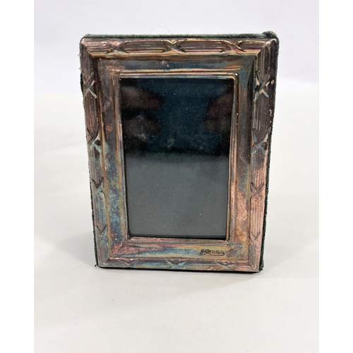 602 - A  silver picture frame11.5 x 9cm overall ; a brass candle stand; a brass candelabrum