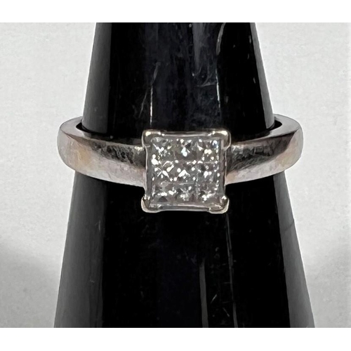 608 - A white metal ring, stamped '750', with 9 square diamonds in square setting