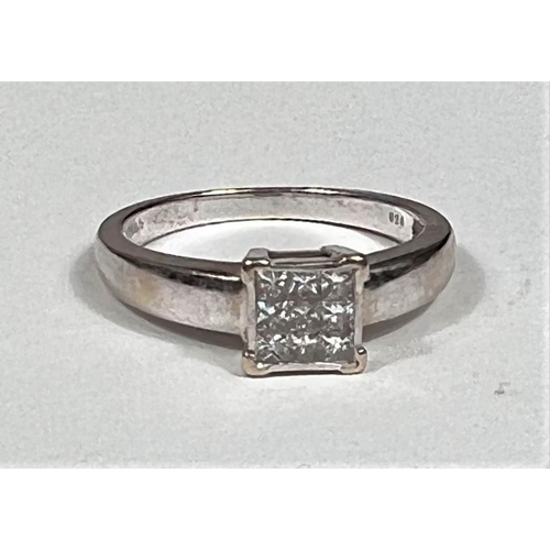 608 - A white metal ring, stamped '750', with 9 square diamonds in square setting