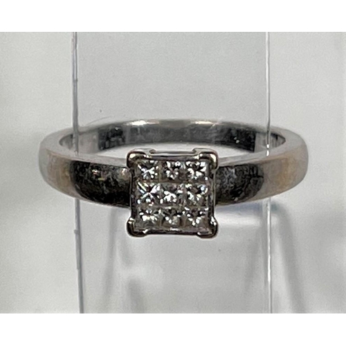 608 - A white metal ring, stamped '750', with 9 square diamonds in square setting