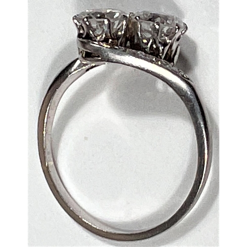 612 - A white metal ring stamped 'Pt', with 2 diamonds in crossover setting, each shoulder set 4 small dia... 