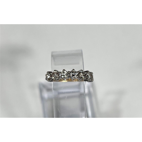 612a - An 18 carat hallmarked gold half eternity ring set 7 diamonds, 3.5mm diameter of stones approx