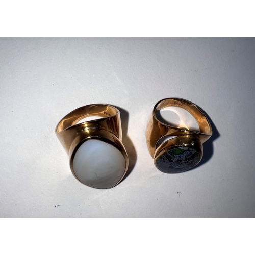 615 - A 9 carat hallmarked gold lady's dress ring on broad shank with inset oval mother of pearl; a simila... 