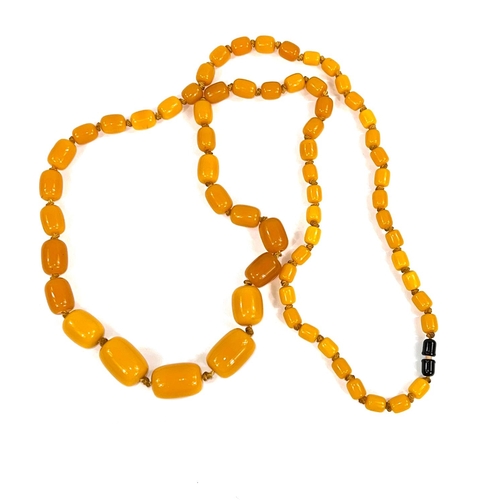 626 - A string of graduated butterscotch beads, 1 - 3cm, 118cm length