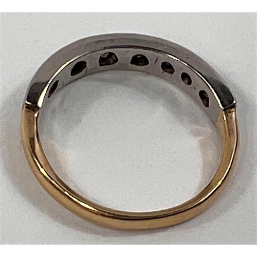 627 - A half eternity ring set with 7 small diamonds on yellow metal shank, stamped 18ct, size K, 2.4gms