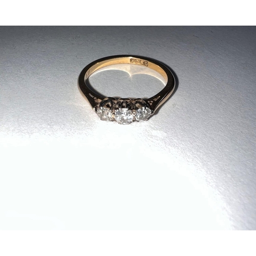 640 - A yellow metal dress ring stamped ‘18ct’ set 3 small diamonds (central stone approximately •1 carat)... 