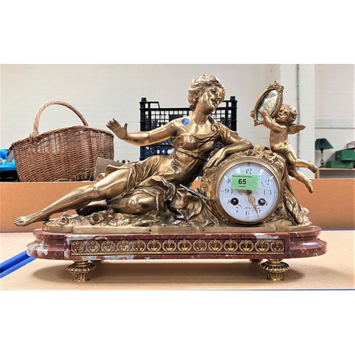 65 - A Louis XVI style mantel clock in ormolu case in the form of a reclining woman with cherub holding a... 