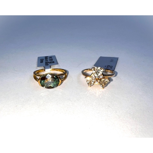 657A - 2 9 carat hallmarked gold dress rings, 1 set with green oval colour change Andesine 2.26 carats, siz... 