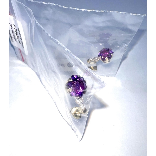 665 - A pair of 9ct hallmarked gold earrings each set with Snowflake Moroccan Amethysts