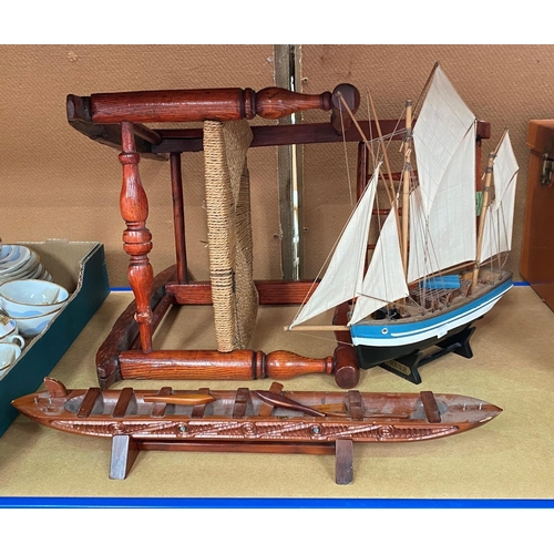 67 - A 19th century child's spindle back rocking chair with raffia seat, a model ship and a Maori boat