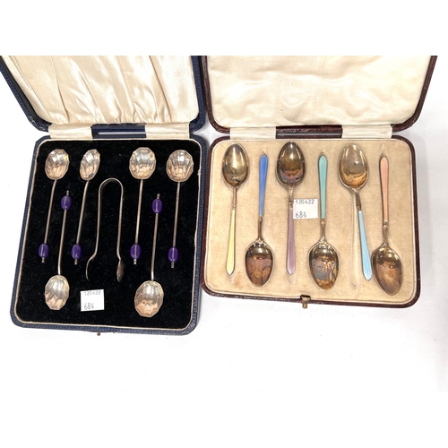 684 - A hallmarked silver and coloured enamel set of coffee spoons,, Birmingham 1931, cased; a set of hall... 