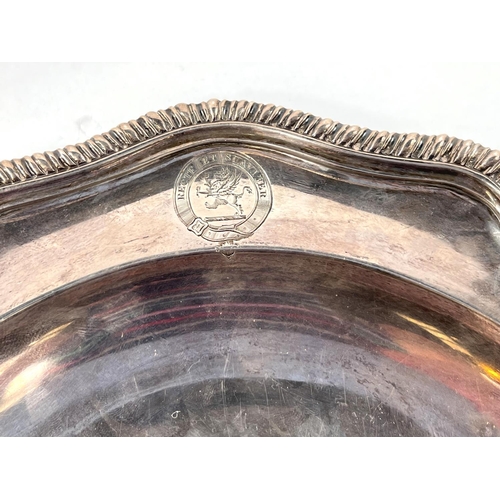 700 - A Georgian hallmarked silver shallow dish with gadrooned wavy rim, monogrammed, London 1817, maker J... 