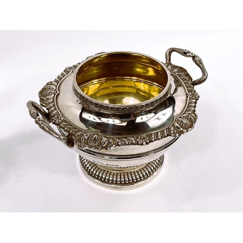 704 - A Georgian style hallmarked silver milk jug and sugar bowl of circular form with gadrooned and shell... 